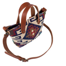 Load image into Gallery viewer, Overhead view of women&#39;s southwestern mini tote handbag. Chestnut brown leather handles with a removable, buckle adjustable strap.  Antique brass hardware.
